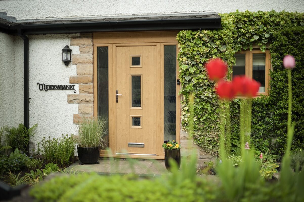 A composite door with a woodgrain finish